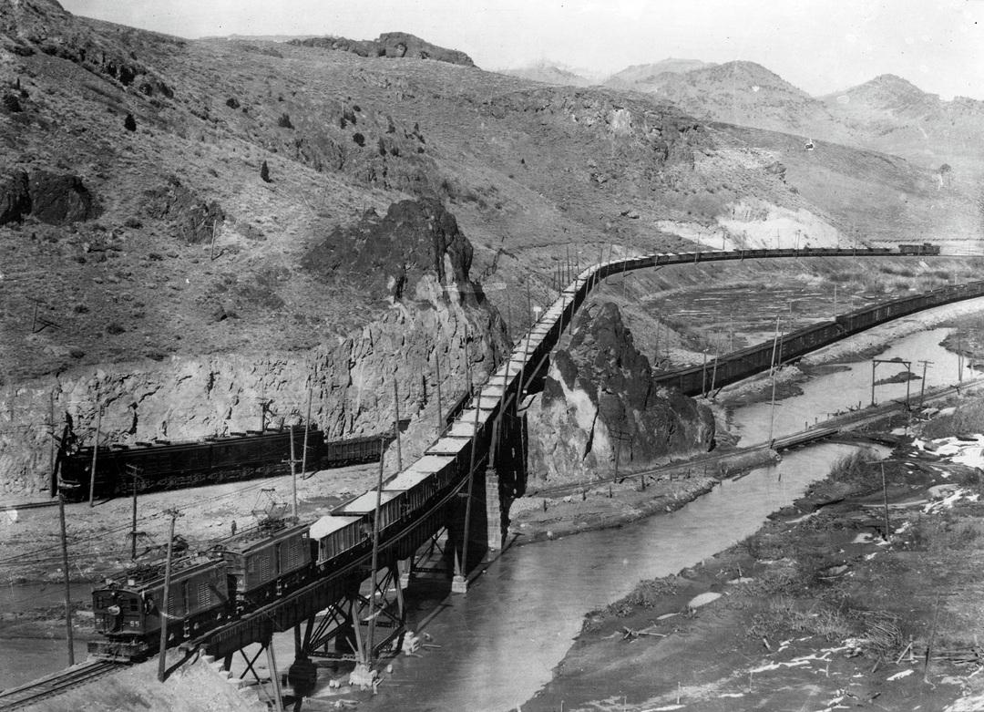 Trains on two electrified railroads in Silver Bow canyon.